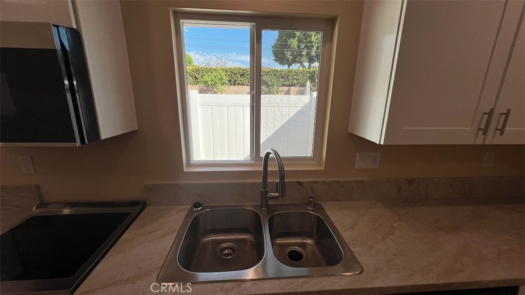 10908 Canby Avenue Porter Ranch, CA 91326 - Photo 8 of 26 a kitchen with a sink a stove and cabinets