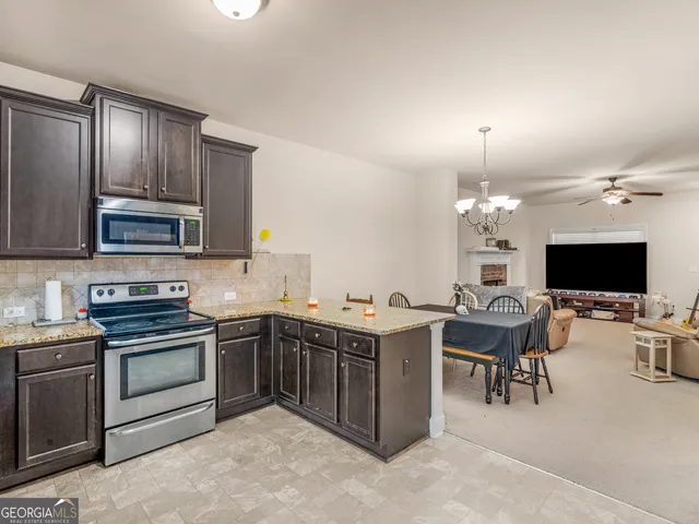 a view of kitchen with sink stove and microwave
