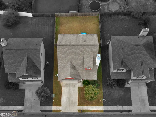 an aerial view of residential houses with outdoor space