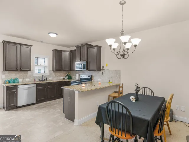 a kitchen with a table chairs stove and cabinets