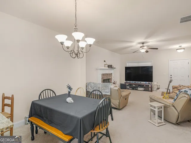 a living room with furniture a chandelier and a flat screen tv