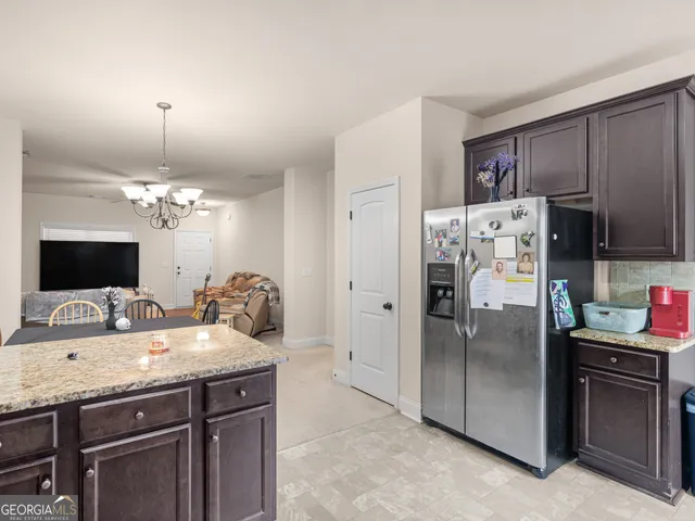 a kitchen with a refrigerator and a sink