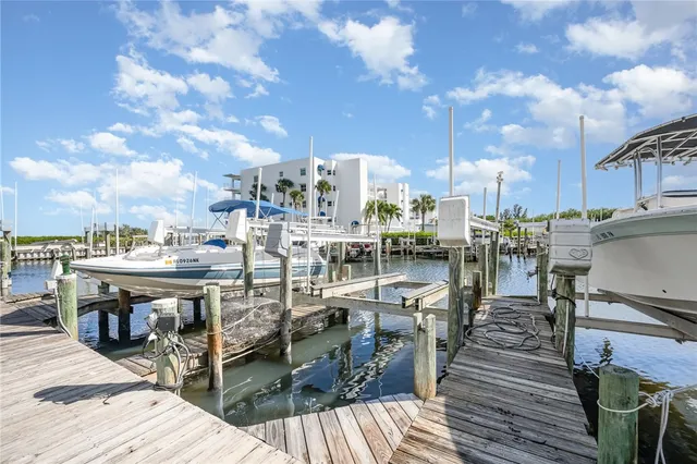 a view of a rooftop deck with chairs and wooden floor