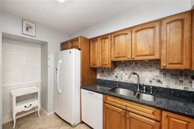a kitchen with stainless steel appliances granite countertop a refrigerator sink and cabinets
