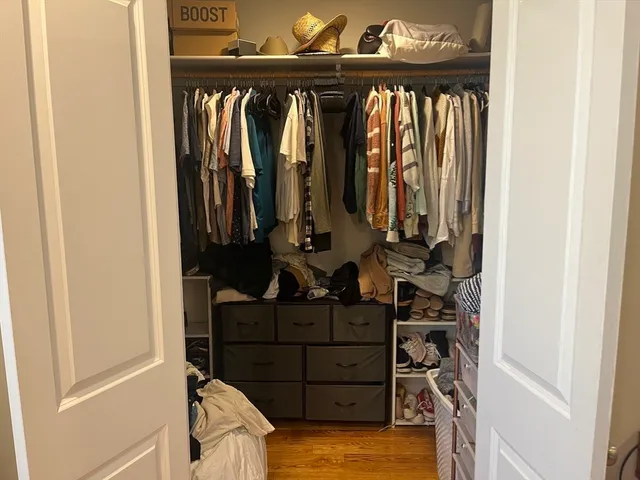 a view of walk in closet with clothes