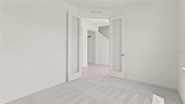 a bathroom with a shower and a glass door