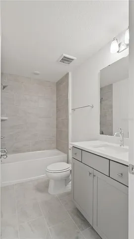 a bathroom with a shower sink and mirror
