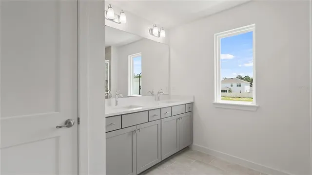 a bathroom with a shower sink and mirror