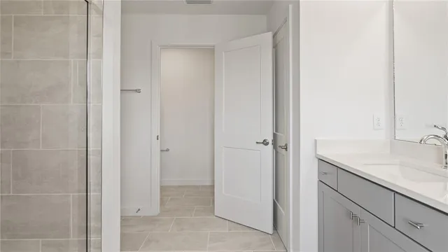 a white toilet sitting next to a bathroom sink