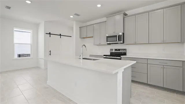 a kitchen with a sink and cabinets