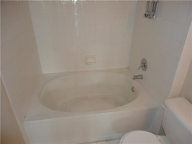 791 North Pine Island Road, Unit 214 Plantation, FL 33324 - Photo 18 of 23 a white bath tub sitting next to a white toilet