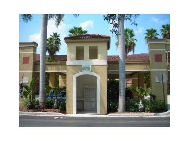 791 North Pine Island Road, Unit 214 Plantation, FL 33324 - Photo 3 of 23 a view of a brick house with a floor to ceiling window and potted plants