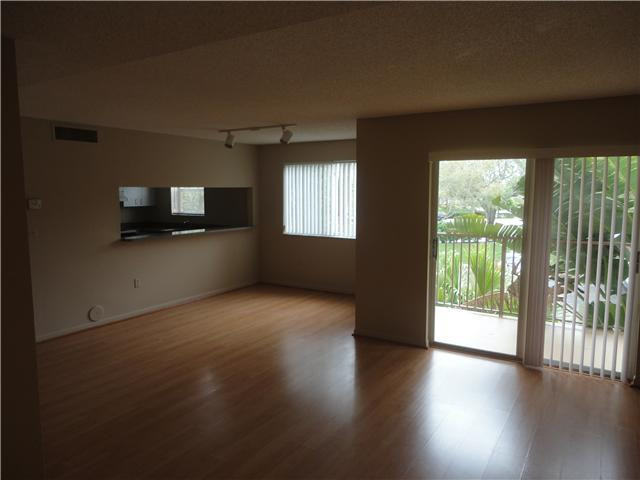 791 North Pine Island Road, Unit 214 Plantation, FL 33324 - Photo 6 of 23 an empty room with wooden floor and windows