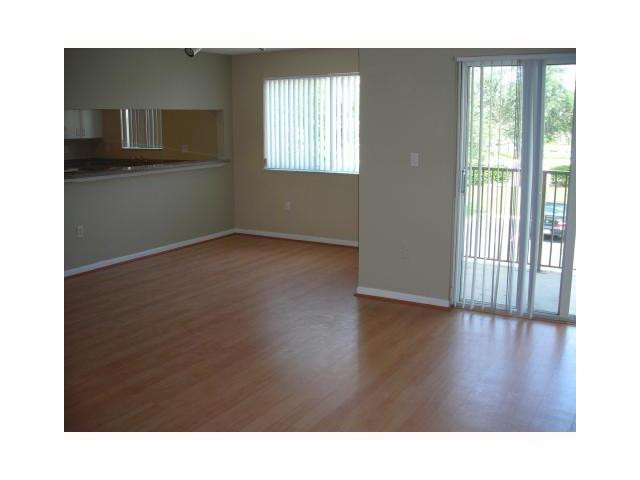 791 North Pine Island Road, Unit 214 Plantation, FL 33324 - Photo 7 of 23 a room with wooden floor and windows