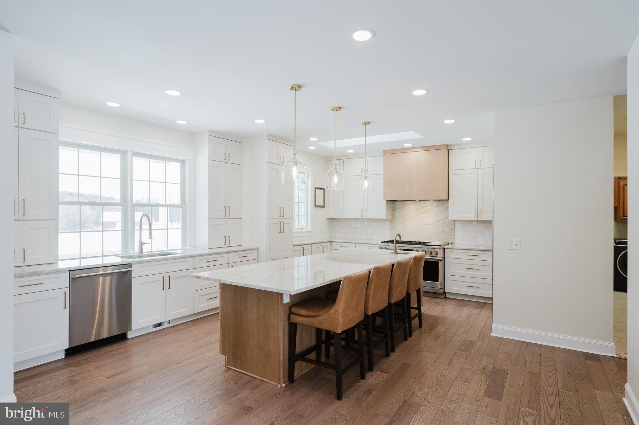 4532 Flintville Road Whiteford, MD 21160 - Photo 17 of 83 a large kitchen with stainless steel appliances granite countertop a lot of counter space and wooden floors