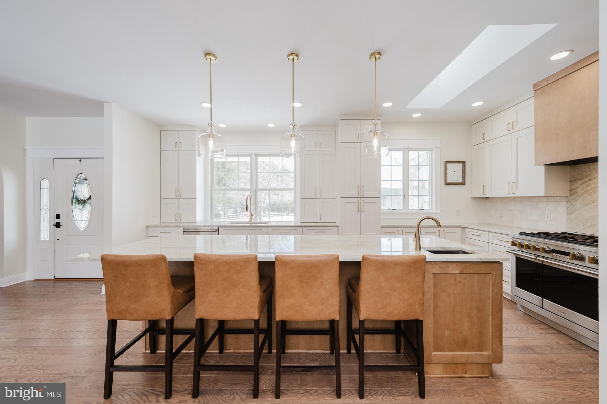 4532 Flintville Road Whiteford, MD 21160 - Photo 27 of 83 a kitchen with stainless steel appliances granite countertop a stove a sink a dining table and chairs with wooden floor