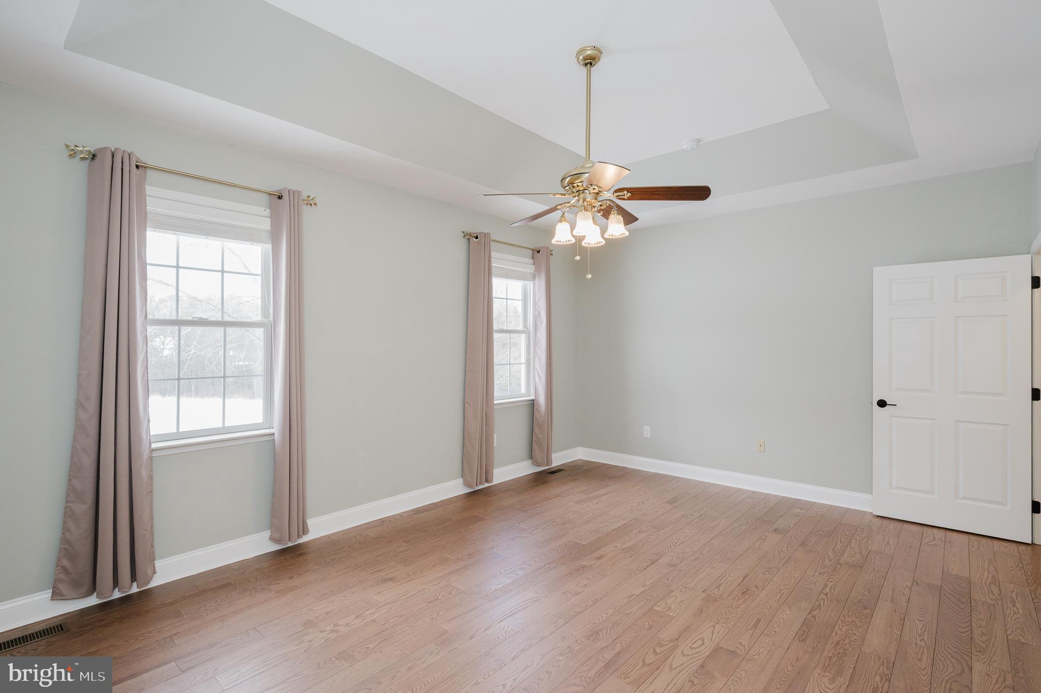 4532 Flintville Road Whiteford, MD 21160 - Photo 43 of 83 an empty room with wooden floor chandelier and windows
