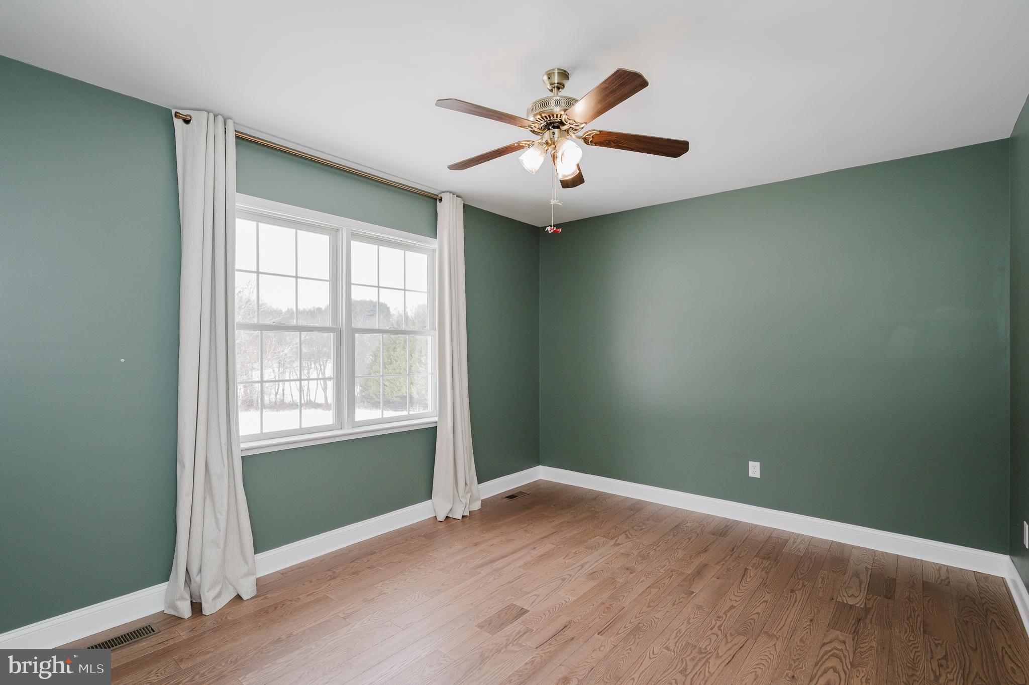 4532 Flintville Road Whiteford, MD 21160 - Photo 49 of 83 an empty room with wooden floor fan and windows