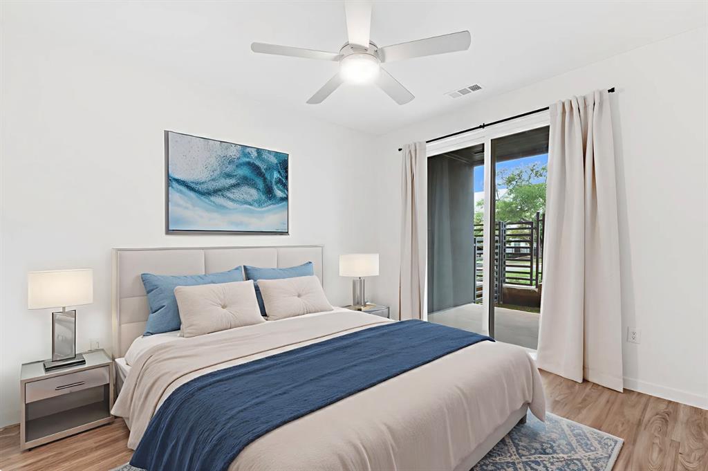 4801 Springdale Road, Unit 2010 Austin, TX 78723 - Photo 9 of 28 Bedroom with access to outside, light wood finished floors, and ceiling fan