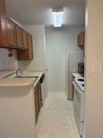 a kitchen that has a sink and a stove