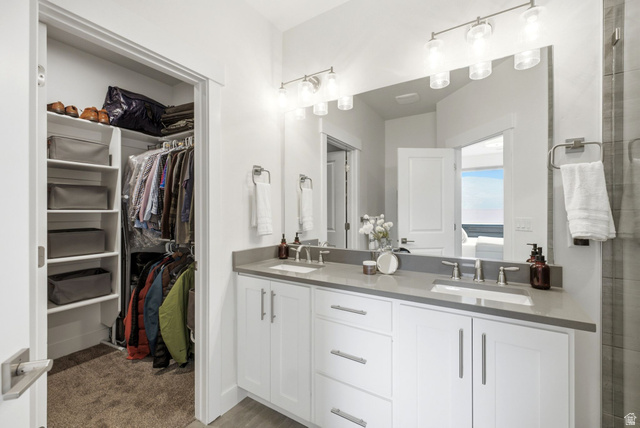 3355 Santa Fe Road Park City, UT 84098 - Photo 18 of 45 Double vanity featuring white cabinetry, grey countertops, and undermount sinks