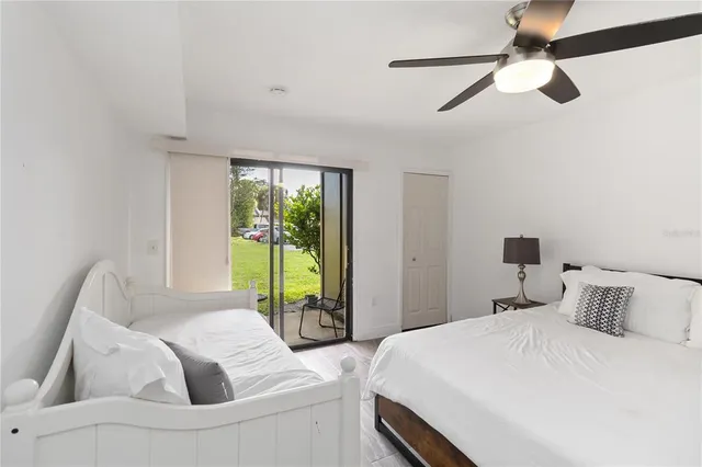 a bedroom with a bed and a large window