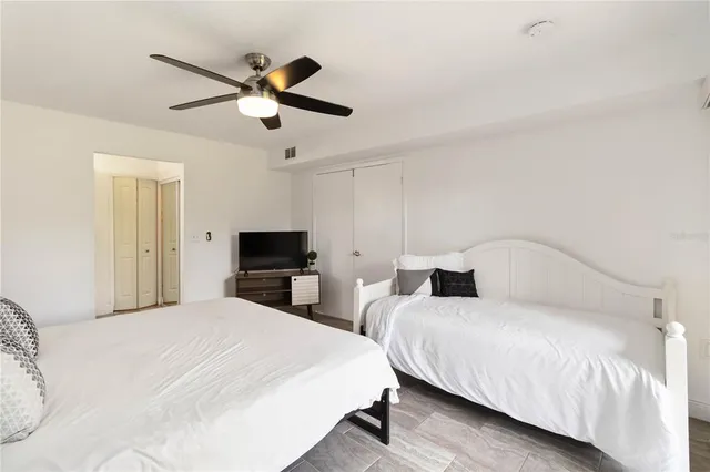 a bedroom with two bed and a chandelier