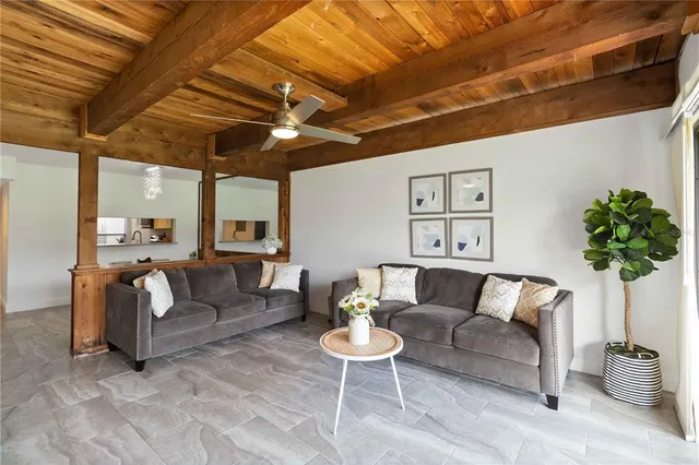 a living room with furniture and a potted plant