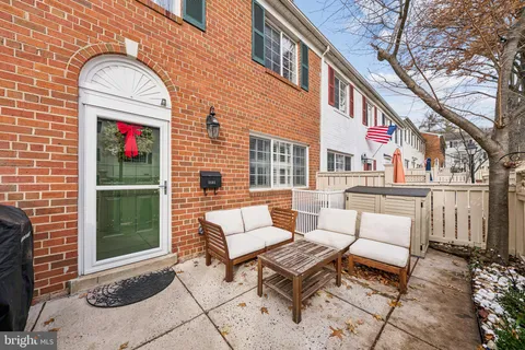 a view of a patio with a table and chairs