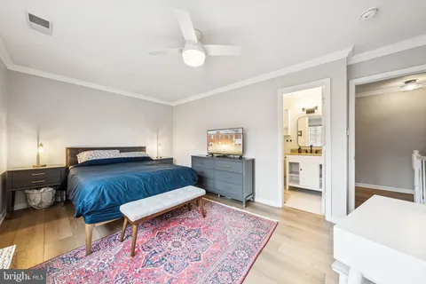 a bedroom with furniture and a rug