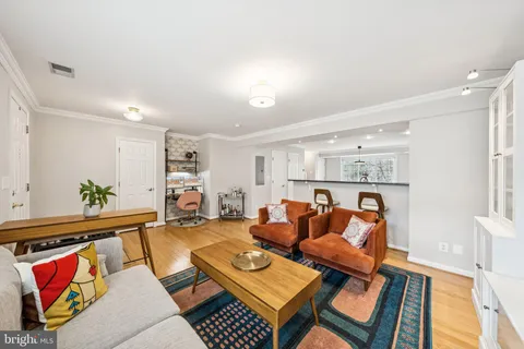 a living room with furniture and kitchen view
