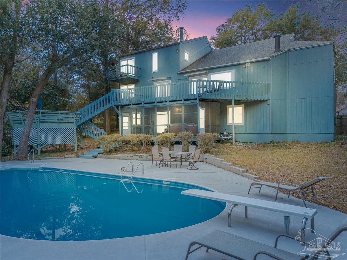 a view of house with outdoor space and swimming pool