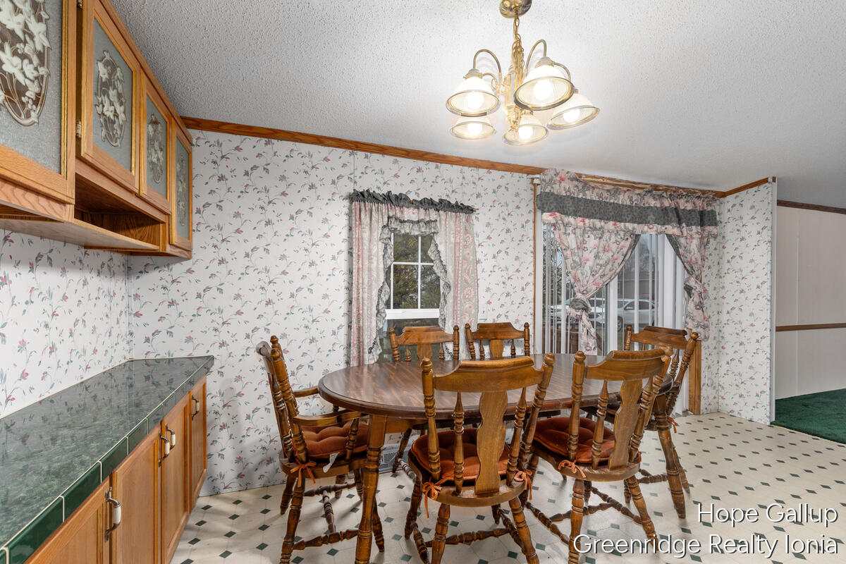 360 East Tuttle Road, Unit 183 Ionia, MI 48846 - Photo 11 of 16 DINING AREA AND SLIDER TO DECK