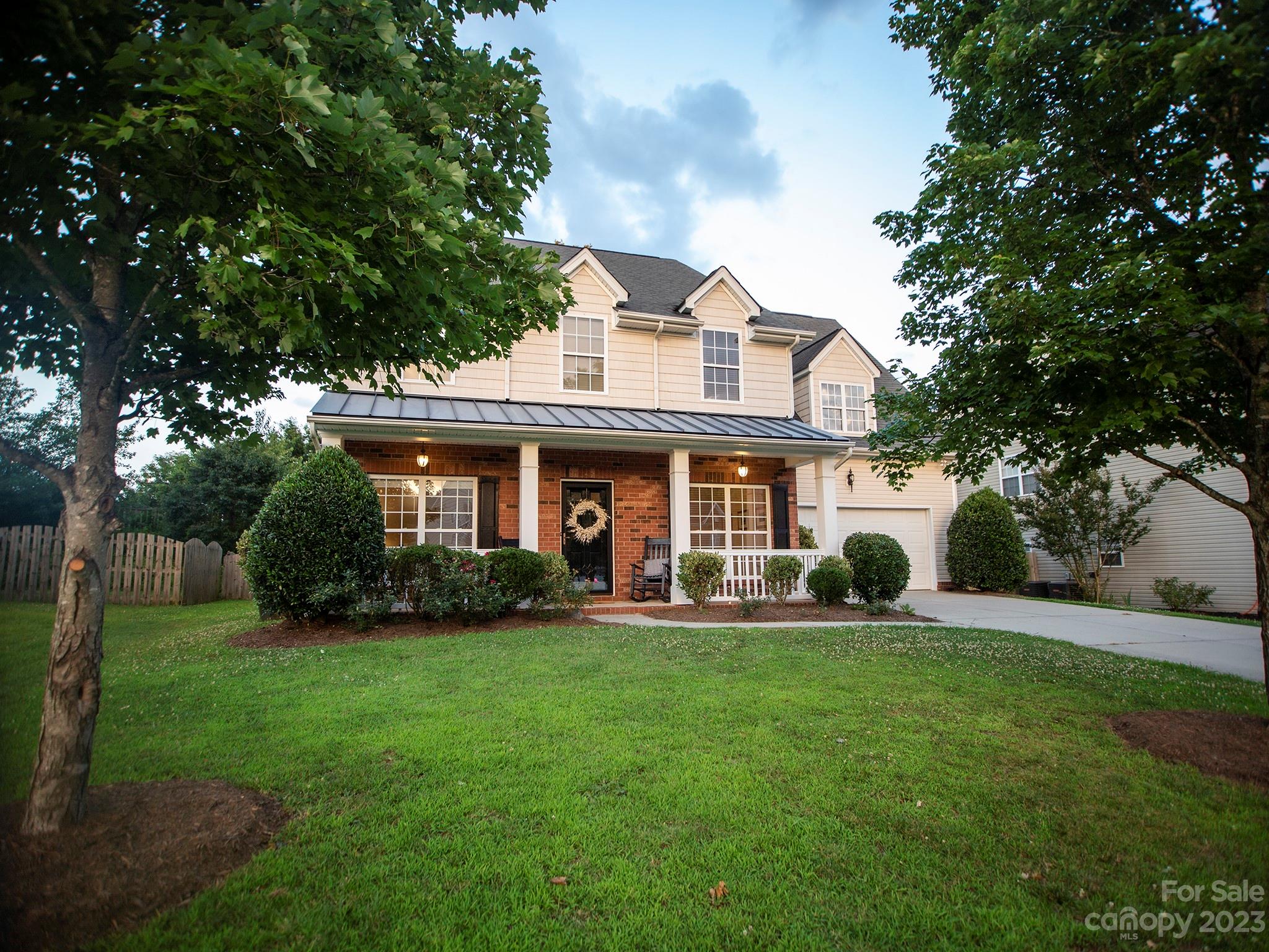 a view of a house with a yard porch and sitting area
