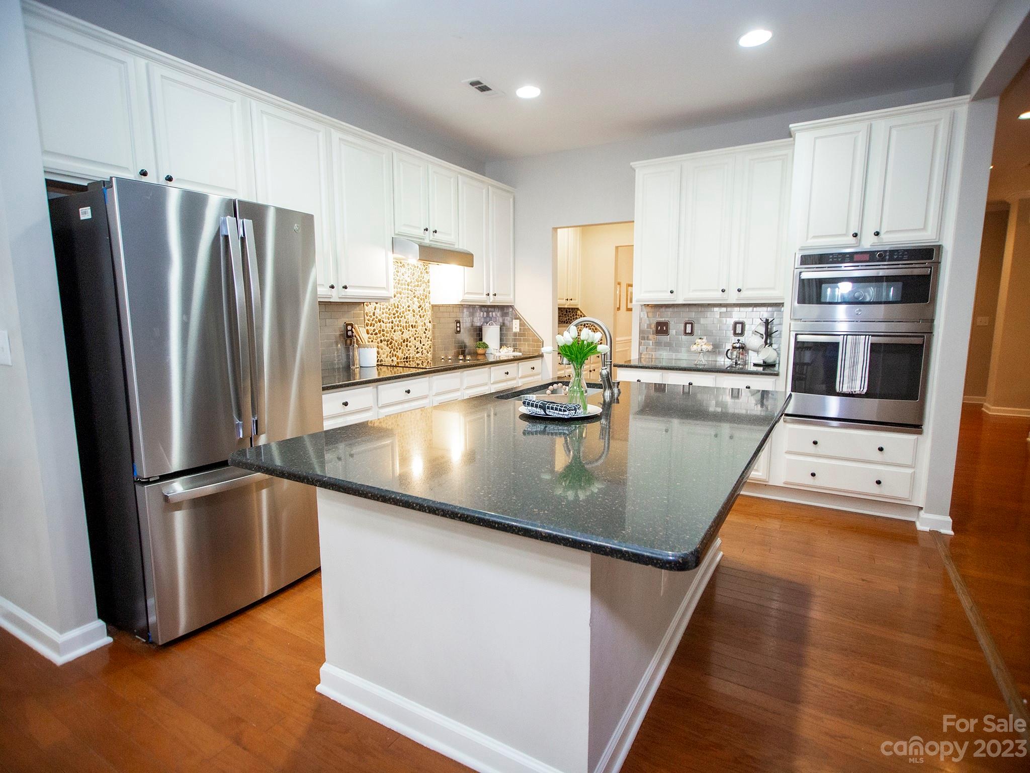 3437 Norwich Road Fort Mill, SC 29715 - Photo 11 of 46 a kitchen with stainless steel appliances granite countertop a refrigerator a sink a stove and white cabinets