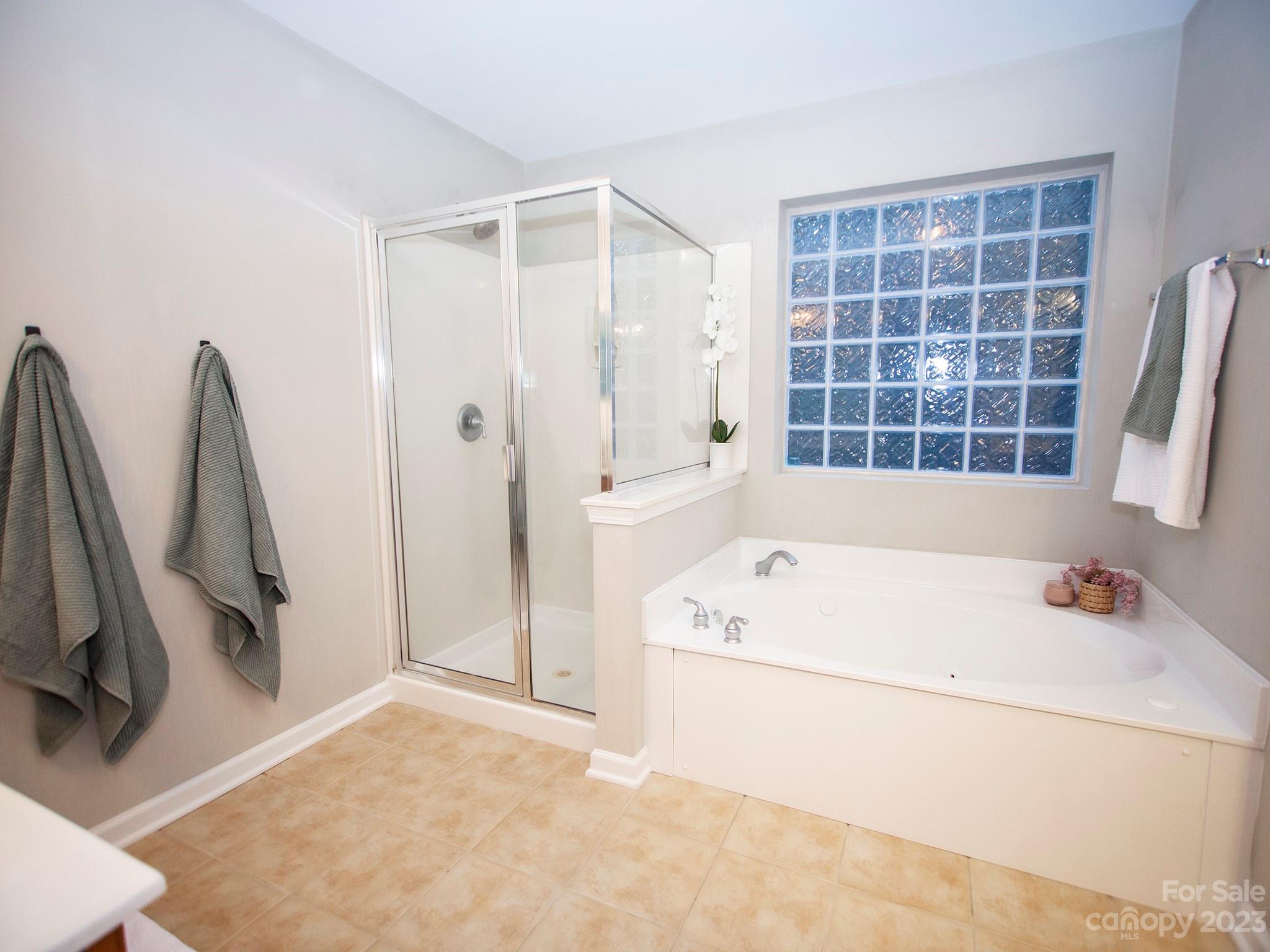3437 Norwich Road Fort Mill, SC 29715 - Photo 35 of 46 a bathroom with a tub a sink a vanity and a shower