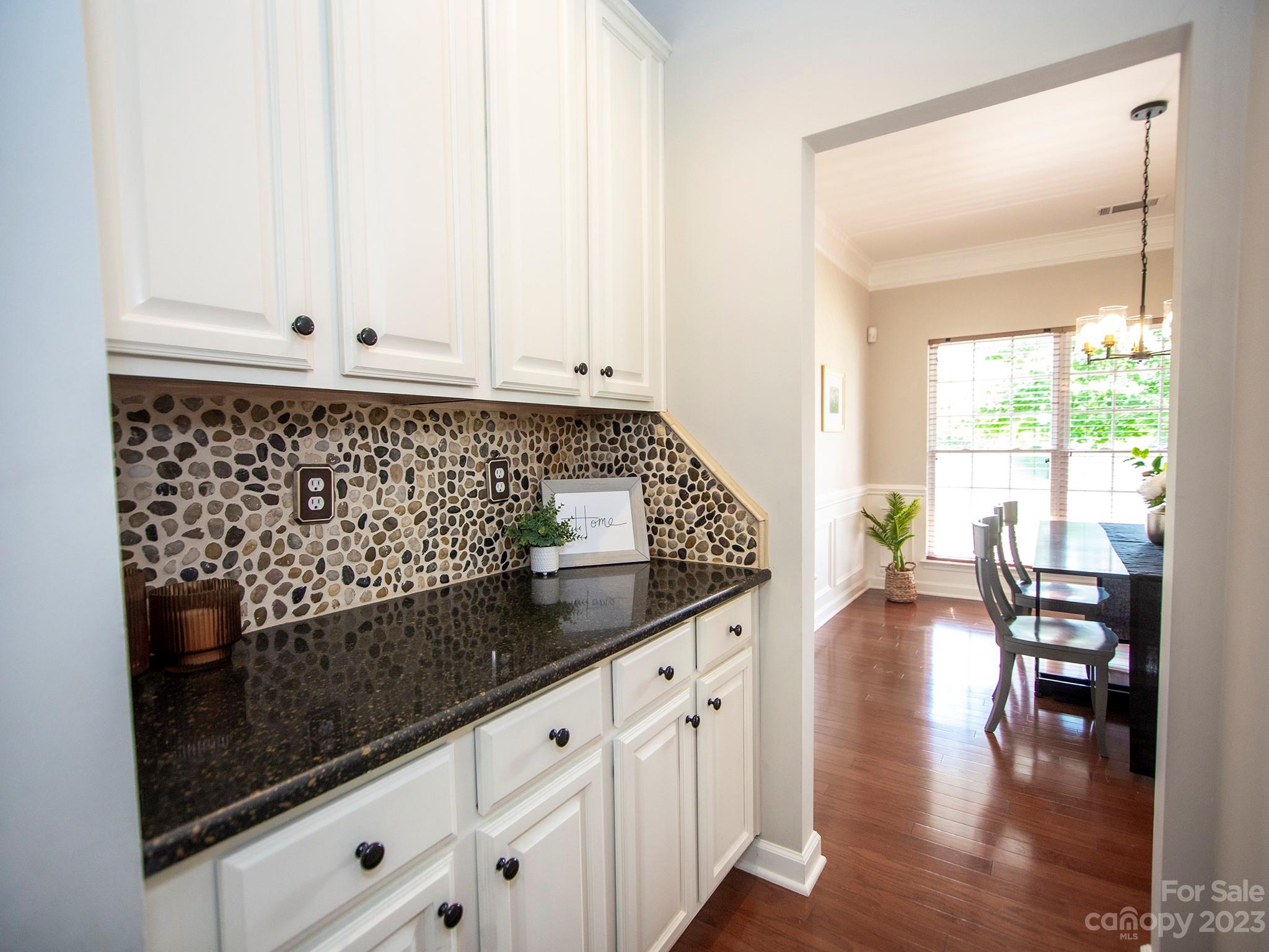 3437 Norwich Road Fort Mill, SC 29715 - Photo 10 of 46 a kitchen with granite countertop white cabinets and wooden floor
