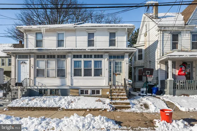 a front view of a building with a yard from a large window