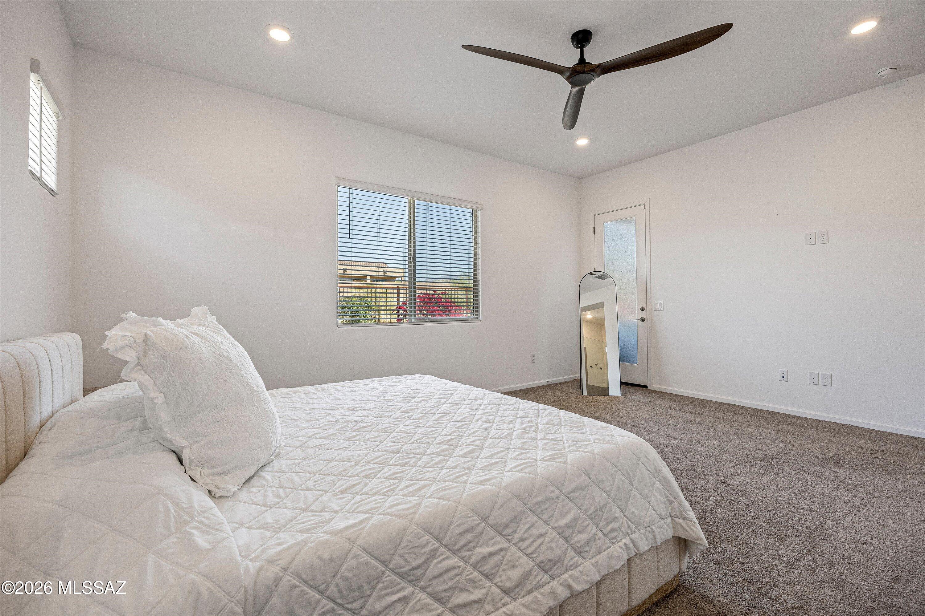 5196 West Ridgemont Court Tucson, AZ 85742 - Photo 22 of 46 Primary en suite featuring a door that opens directly to the back patio