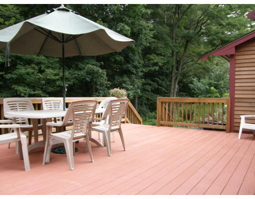19 Oxbow Road Lexington, MA 02421 - Photo 18 of 23 a patio with wooden floor a yard a table and chairs