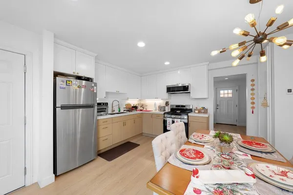 a kitchen with stainless steel appliances granite countertop a refrigerator and stove