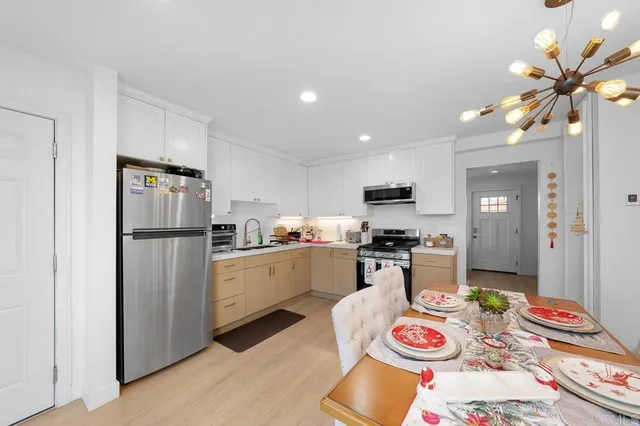 a kitchen with stainless steel appliances granite countertop a refrigerator and stove