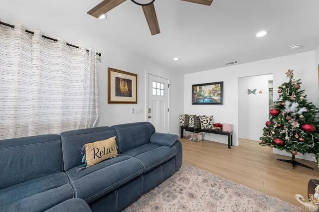 a living room with furniture and flowers
