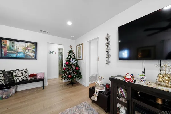 a bedroom with furniture and a flat screen tv