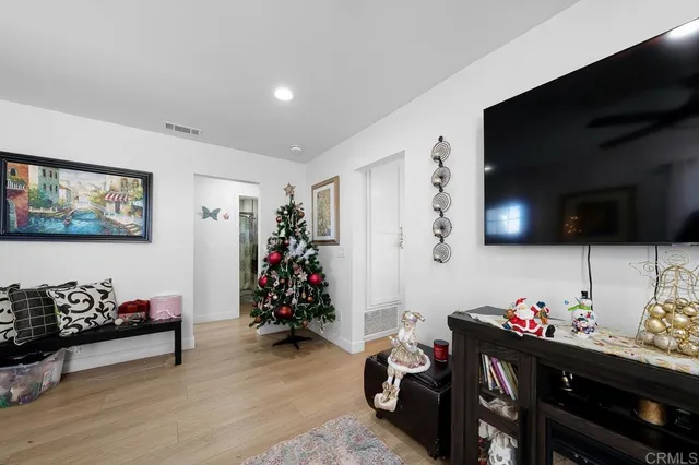 a bedroom with furniture and a flat screen tv