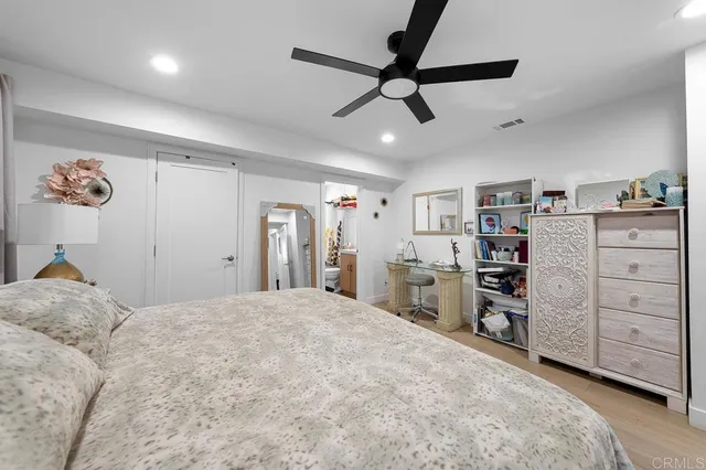 a living room with furniture and a ceiling fan
