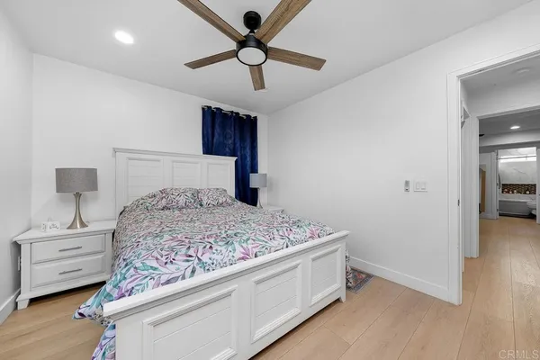 a bedroom with a bed and a tv