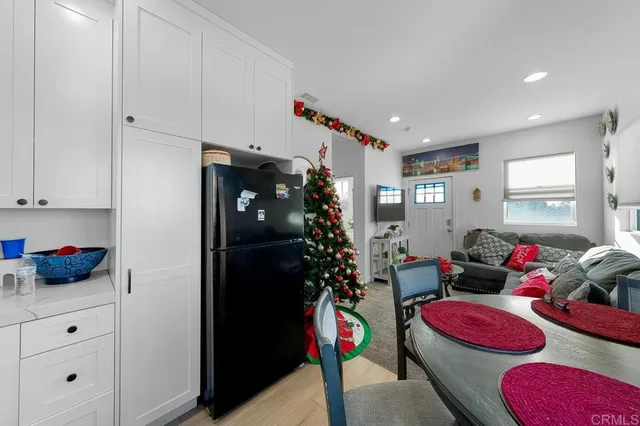 a kitchen with stainless steel appliances kitchen island granite countertop a stove a sink dishwasher and cabinets with wooden floor