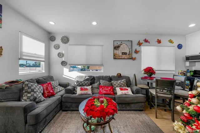 a bedroom with a bed and a flat tv screen on dresser