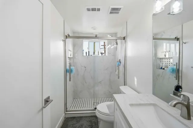 a room with a bed and a ceiling fan